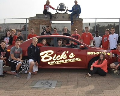 Bick's Driving School students around Bick's car